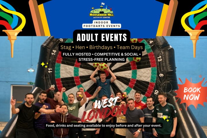Group of people in front of a large inflatable dartboard at Horsenden Hill Activity Centre event.