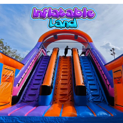 Colorful inflatable slide with people climbing, labeled 'Inflatable Land' at the top.