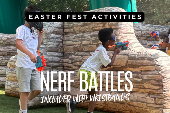 Children in masks playing Nerf battles behind stone-patterned barriers at an Easter fest activity.